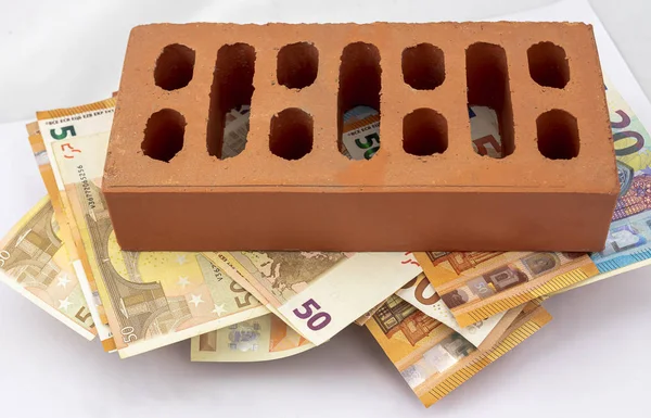 Brick on fifty and twenty euros bills — Stock Photo, Image