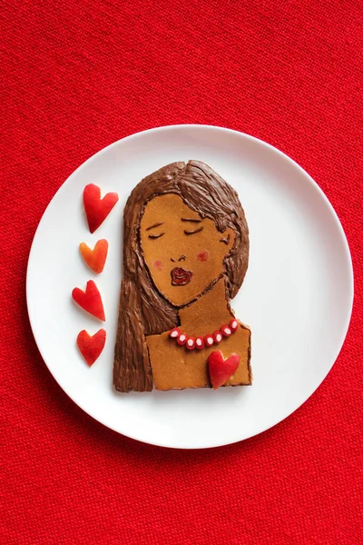 Beautiful, sadness girl (from pancakes) with sexy red lips (from raspberry jam) dreaming for him or her. Waiting for LOVE. Edible food art, top view