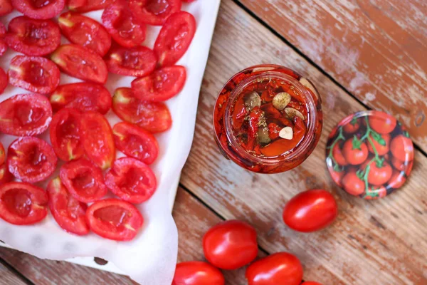 Zongedroogde Tomaten Een Glazen Pot Gesneden Tomaten Bakplaat Houten Achtergrond — Stockfoto