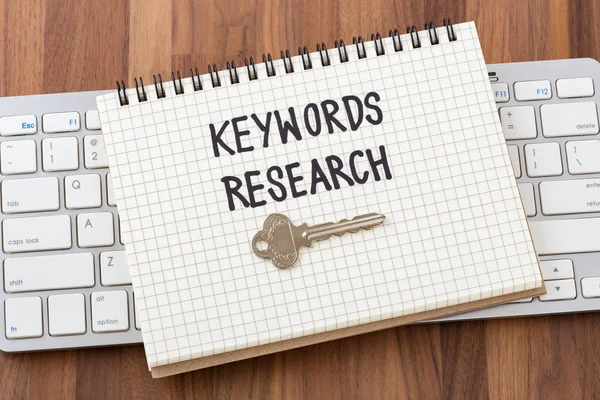 Keywords research for seo concept with key and computer keyboard