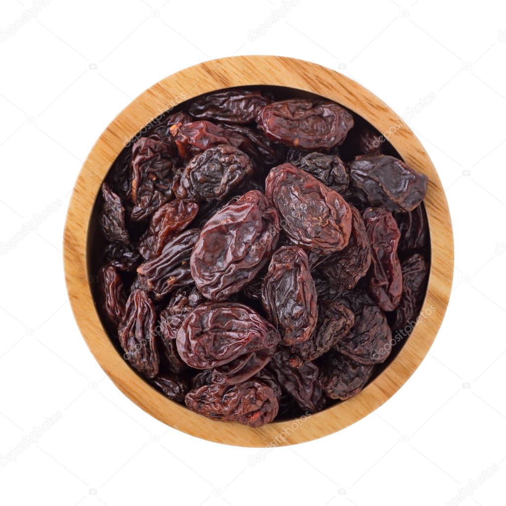 Jumbo raisins in wooden bowl isolated on white background