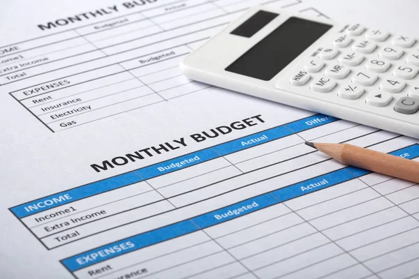 Monthly budget concept with monthly budget sheet and white calculator