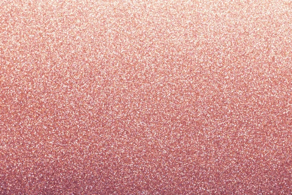 Rose gold glitter background, shiny wrapping paper defocused