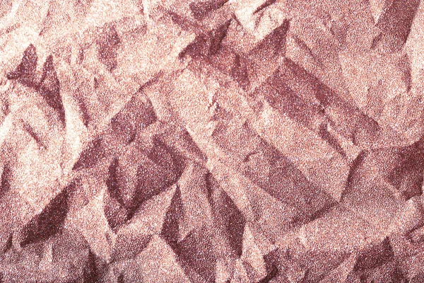 Rose gold glitter background, shiny crumpled wrapping paper texture, pink champagne