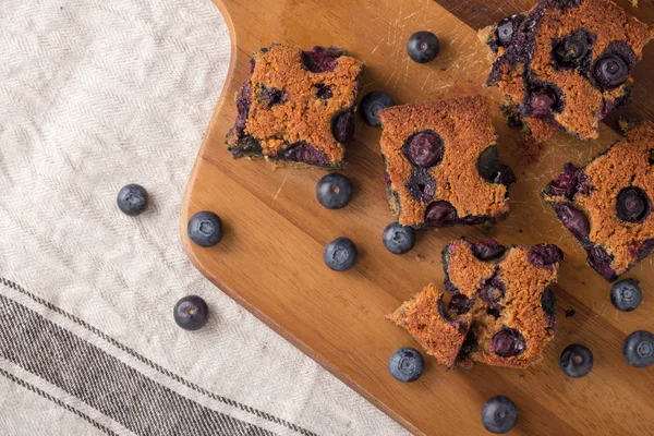 Blueberry square bars on wooden board with blueberries, paleo low carb dessert