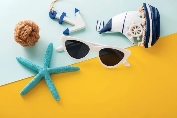 Sunglasses and accessories on yellow and blue background — Stock Photo, Image