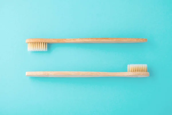 Wooden toothbrushes on blue background — Stock Photo, Image