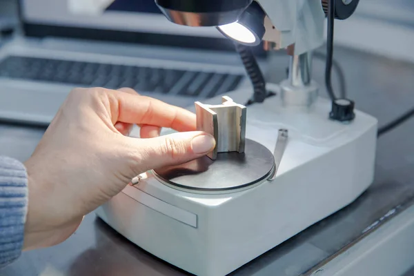 Close-up shot of laboratory microscope with steel sample