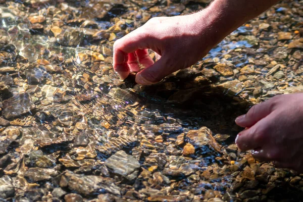 Männliche Europäische Hand Erfrischt Meditativer Zen Atmosphäre Kristallklaren Wasser Eines lizenzfreie Stockbilder