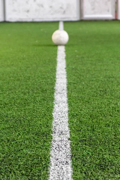 White line on indoor soccer field with football on the playground is ready for kick off as tournament or training on artificial grass to play futsal or other sport soccer games with goal competition