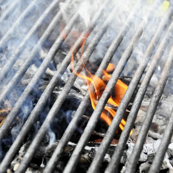 Orange charcoal fire under the grill lattice — Stock Photo, Image