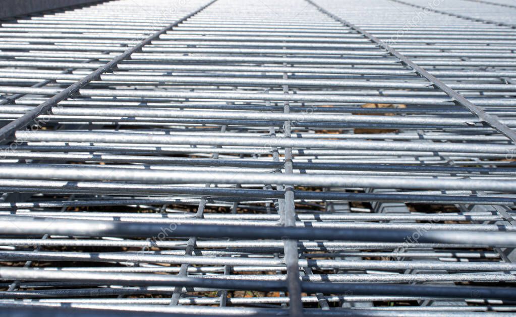 Metal grid industrial background in perspective.Construction art and texture.Metal material.Urban style concept.Outdoor renovation.Building the wall.