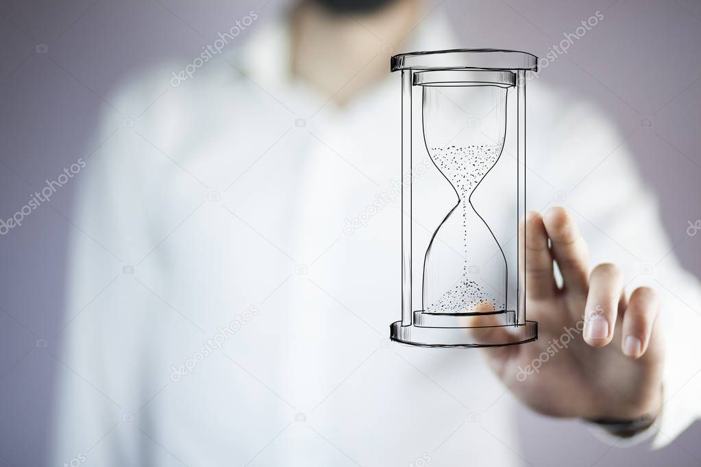 Man's hand touching  hourglass. Business