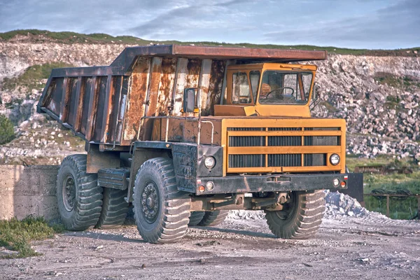 Heavy mining truck driving through opencast