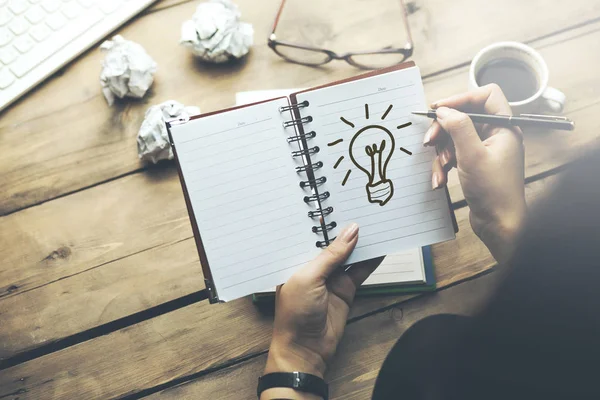 Woman Drawing Lighting Bulb Notebook Keyboard Stationary Table — Stock Photo, Image