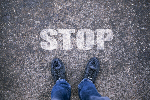 man on  road with sign  Stop