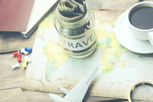 saving money for travel, money on map