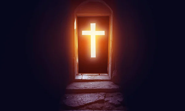 Light entering through cross door to a church