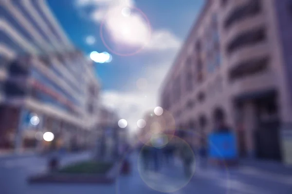 people and buildings in bokeh on street