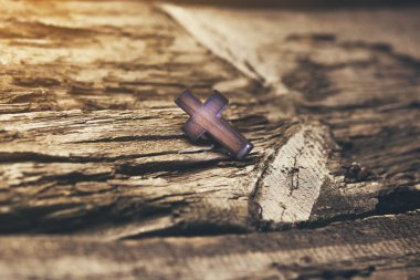 wooden cross on the wooden  table background clipart