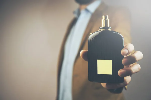 Confident Young Man Showing Scent Bottle — Stock Photo, Image