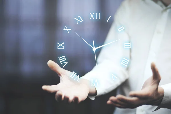 Businessman presenting   clock icon above hands