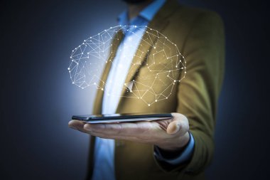 İşadamı el ile beyin simgesi üzerinde ile akıllı telefon yakın çekim 