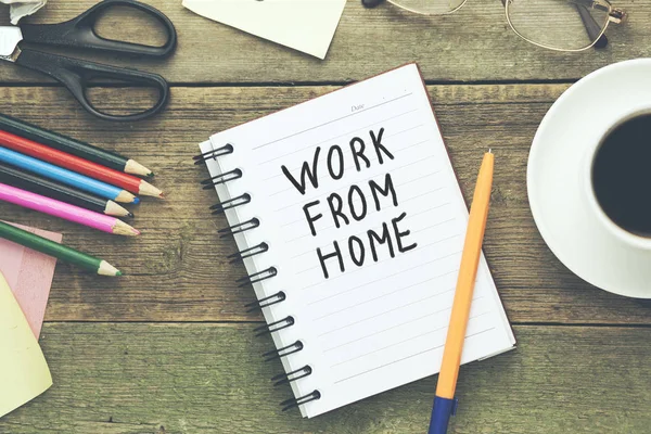 work from home text written on notepad and stationary on table
