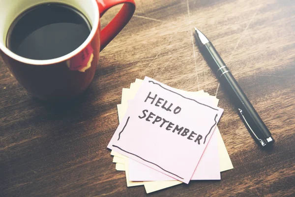Hello September wrote at paper  with coffee cup