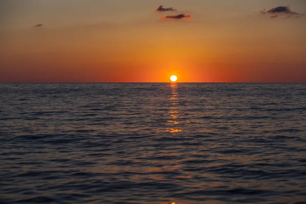 Beautiful orange sunset with blue roaring sea
