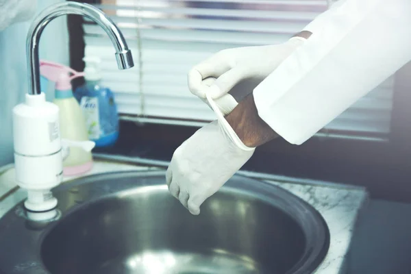 Doctor Putting Sterile Gloves Isolated White — Stock Photo, Image