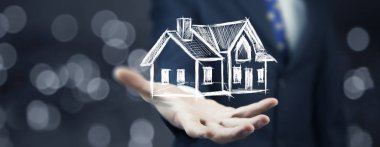 genç adamın elini tutan ev modeli simgesi 