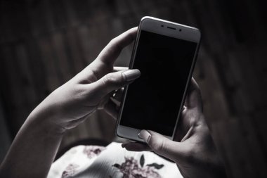 Koyu arkaplanda kadın cep telefonu