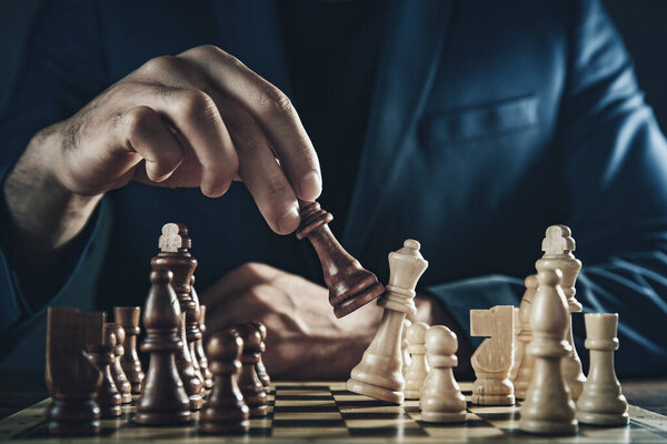 businessman playing a game of chess