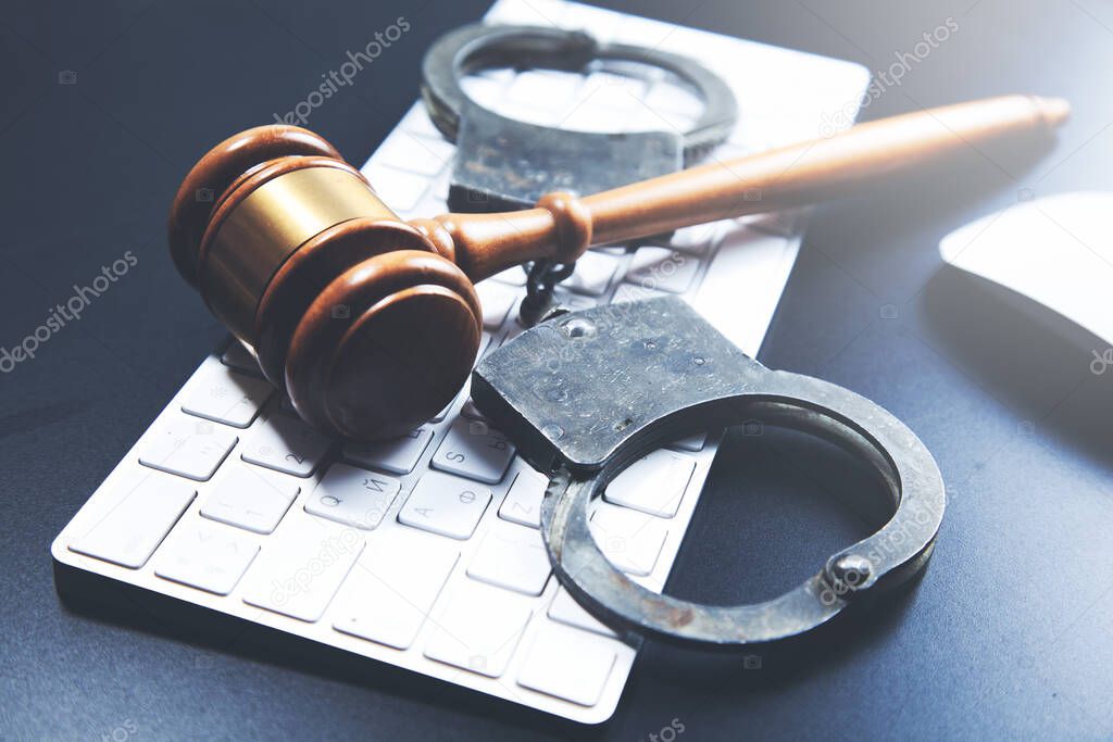 handcuffed with judge on computer keyboard