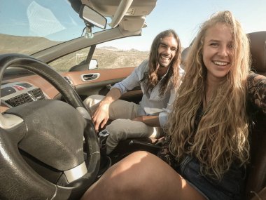 Mutlu genç çift spor arabanın içinde eğleniyor. Kadın ve erkek güzel bir gün için mutlu. Tatil, yolculuk ve ilişki kavramı. Resim