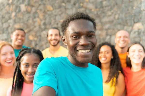 Happy friends multiracial taking selfie. Students having fun with technology trends. Youth, tech and friendship concept. Main focus on the black boy.