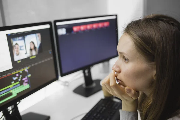 Woman working with video on computer at desk