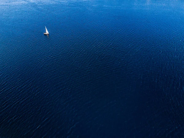 Aerial view of sailboat sailing in open sea