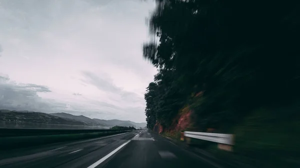Motion blur of highway beside forest