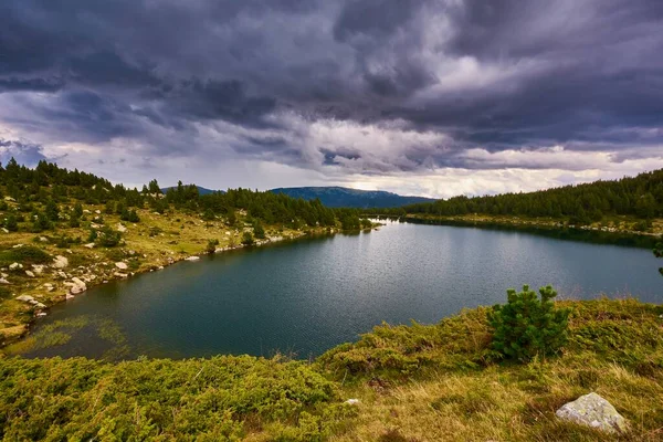Dramatic sky with dramatic stormy clouds over a lake in the Pyrenees