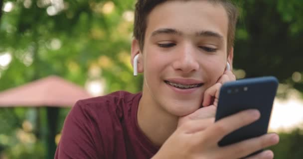 Teen Using Mobile Phone Park Smiling Young Man Using Cell — Stock Video