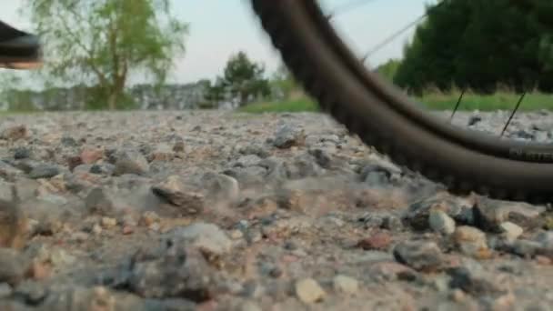 Slow Motion Cinematic Shot Rocks Flying Cyclist Rides Gravel Path — Stock Video