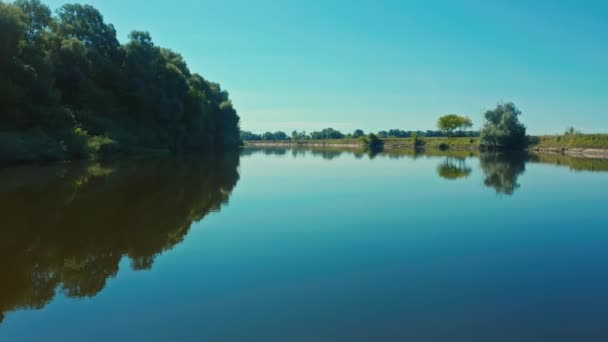 无人机非常接近一条水面光滑的河流 美丽的风景 还有一条蜿蜒的河流 飞越蓝色的湖面 清澈的蓝天反射在平静的水面上 — 图库视频影像