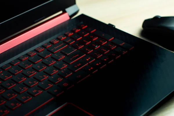 black laptop with red keyboard, close-up