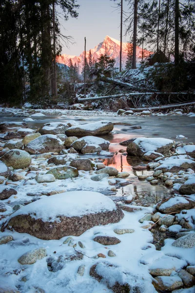 Krivan ve Bela nehri, High Tatras Slovakya. Donmuş nehir ve güneşin dağda batışının ışığı