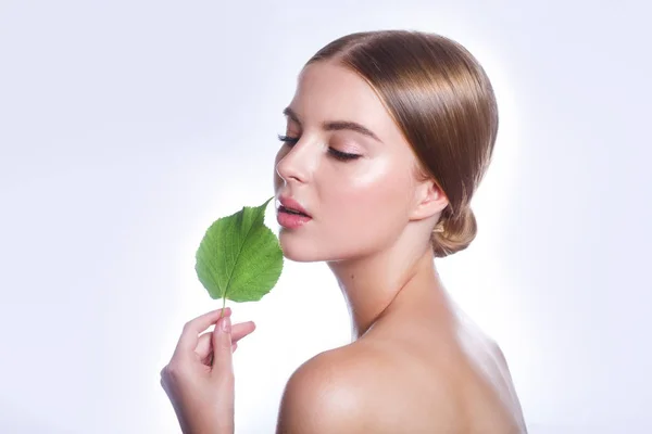 Retrato de rosto de mulher bonita com conceito de folha verde para cuidados com a pele ou cosméticos orgânicos. Retrato de estúdio — Fotografia de Stock