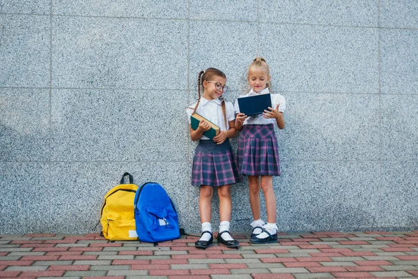 Uczniowie Szkoły Podstawowej Dziewczyny Plecaki Książek Pobliżu Budynku Zewnątrz Początku — Zdjęcie stockowe