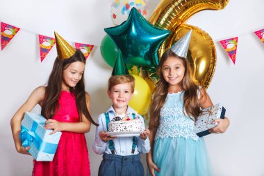 Çocuk Doğum günü partisi arkadaşları tarafından yardım ediliyor kek üzerine mumlar üfleme