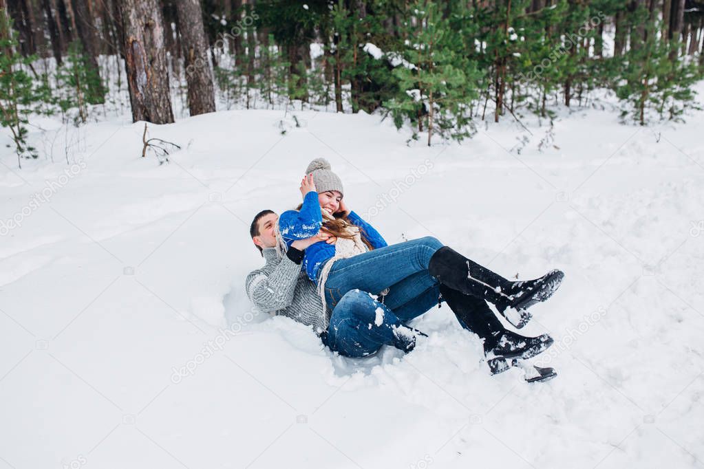 Happy Couple Having Fun Outdoors in Snow Park. Winter vacation